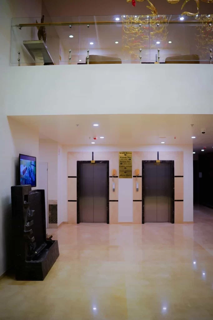 Guest accommodation lobby and elevators at Chattarpur Farms in Nagpur