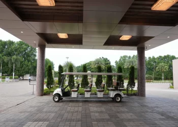 Golf cart and landscaped property at Chattarpur Farms