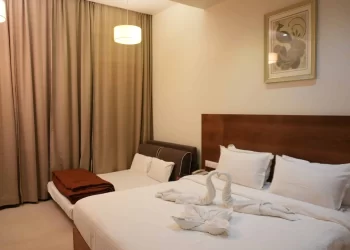 Deluxe room with sofa bed and double bed at Chattarpur Farms in Nagpur