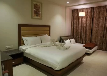 Deluxe room with comfortable bed at Chattarpur Farms in Nagpur