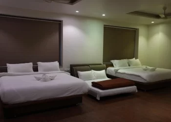 Comfortable family room with two beds at Chattarpur Farms in Nagpur