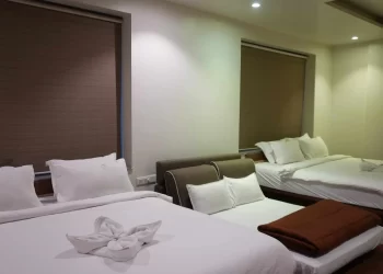 Family room with multiple beds for wedding guests at Chattarpur Farms in Nagpur