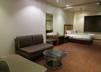Family room with seating and sleeping area at Chattarpur Farms in Nagpur