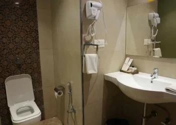 Attached bathroom in a deluxe room at Chattarpur Farms in Nagpur