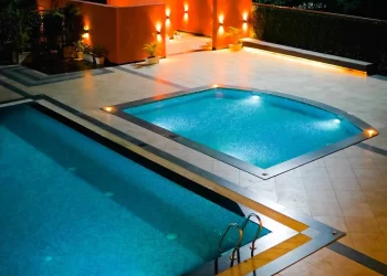 Illuminated Lotus Lagoon swimming pool at Chattarpur Farms in Nagpur